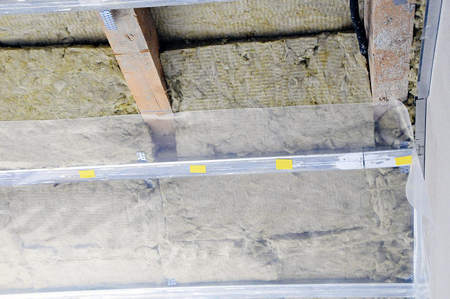 Installation of the vapor barrier on top of the rock wool