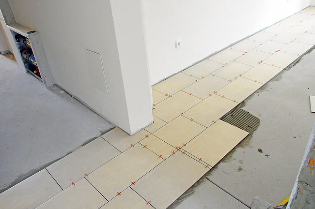Living room tiles being installed