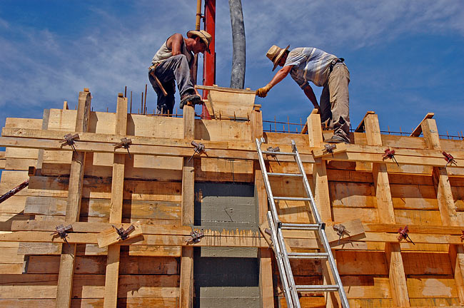 Funnelling concrete into the wooden cast of the armed concrete wall