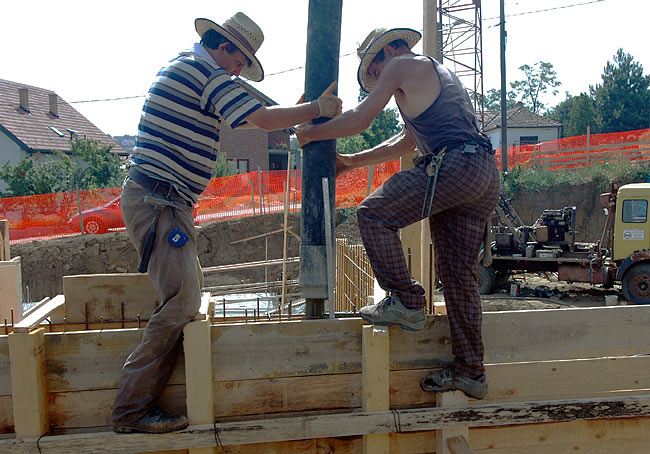 Pouring concrete in the cast of the armed concrete wall