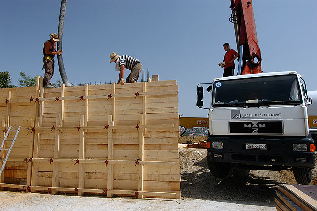 Workers pouring concrete, MARMIL inženjering concrete pump and the operator of the pump - 02